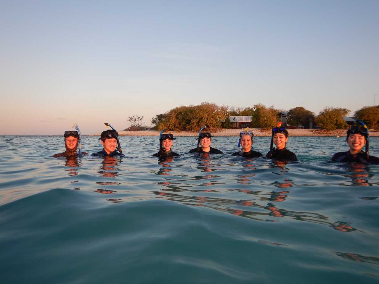Students wearing snorkelling gear in the water at One Tree Island.
